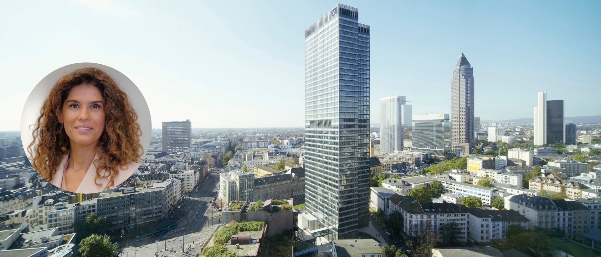Das Bild zeigt eine städtische Skyline mit mehreren Hochhäusern und Gebäuden. Es ist ein klarer Tag mit blauem Himmel. Man sieht moderne Architektur und der Blick erstreckt sich über eine dicht bebaute Stadtlandschaft mit mehreren Bürogebäuden und Wohnhäusern.